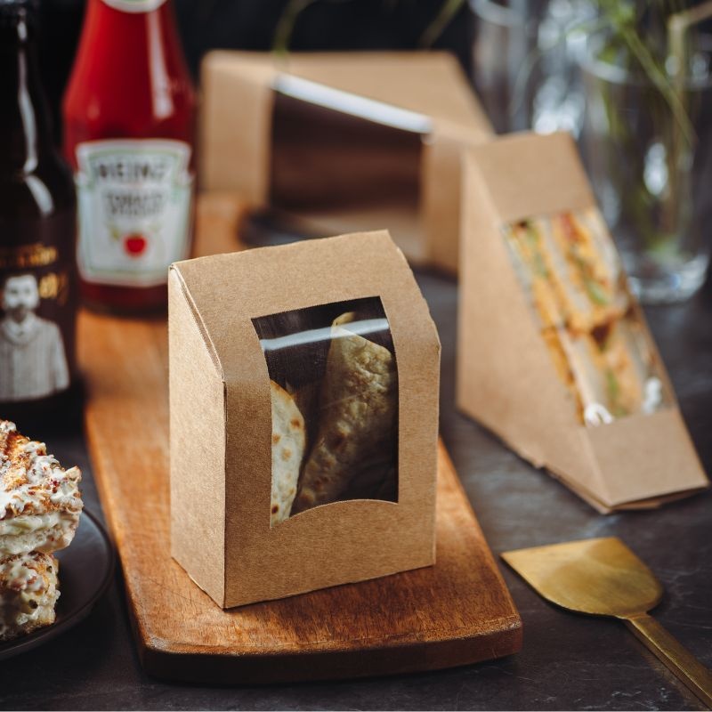 Kraft packaging - sandwich container on a wooden board